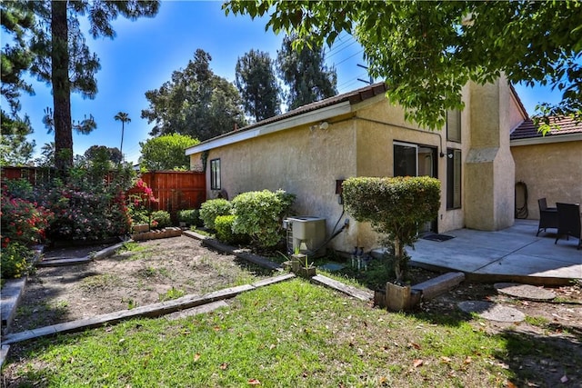 2003 Springcreek Cir, Upland, CA 91784 - view of side of home with fence, a patio, stucco siding, and central AC unit