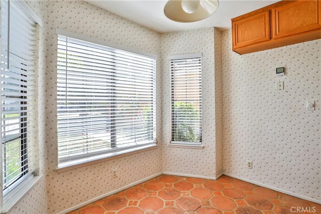 2003 Springcreek Cir, Upland, CA 91784 - unfurnished dining area featuring wallpapered walls, baseboards, healthy amount of natural light, and light tile patterned flooring