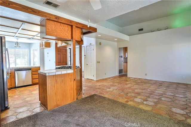 2003 Springcreek Cir, Upland, CA 91784 - kitchen with tile countertops, appliances with stainless steel finishes, a ceiling fan, recessed lighting, and brown cabinetry