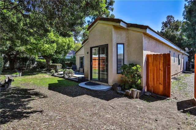 2003 Springcreek Cir, Upland, CA 91784 - view of side of home featuring stucco siding and fence