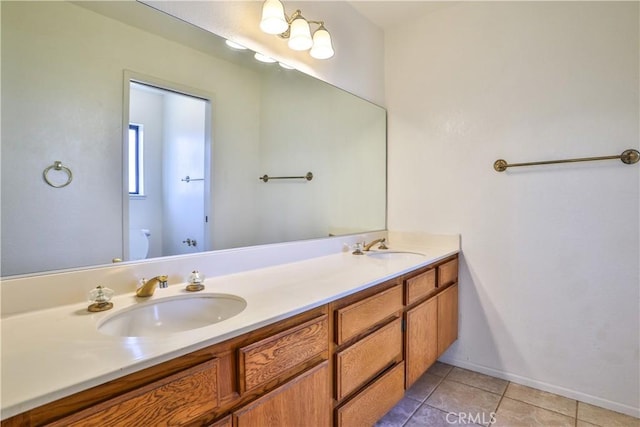 2003 Springcreek Cir, Upland, CA 91784 - bathroom featuring toilet, double vanity, tile patterned flooring, and baseboards