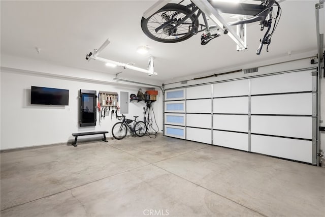 garage featuring electric panel and visible vents