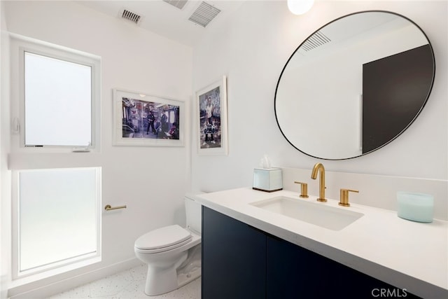 bathroom featuring visible vents, toilet, speckled floor, and vanity