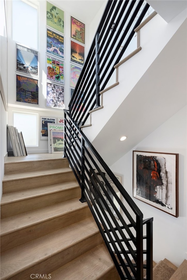staircase featuring recessed lighting