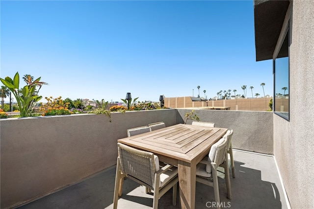 view of patio / terrace with a balcony and outdoor dining area
