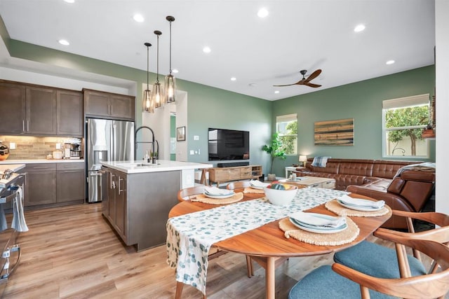 dining room featuring ceiling fan, a healthy amount of sunlight, light wood-type flooring, and recessed lighting