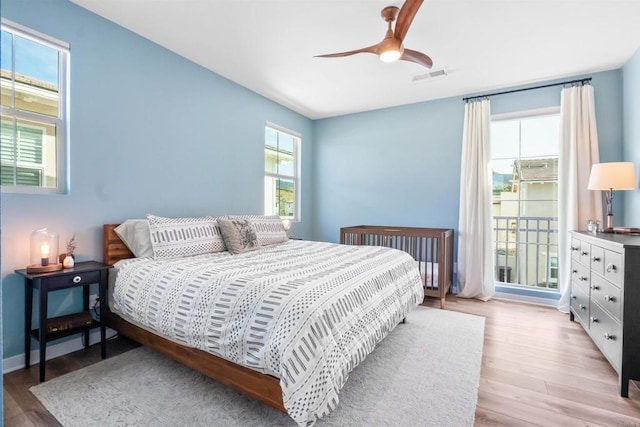 bedroom featuring visible vents, light wood finished floors, and ceiling fan