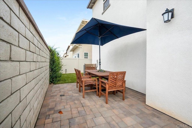 view of patio featuring fence and outdoor dining space