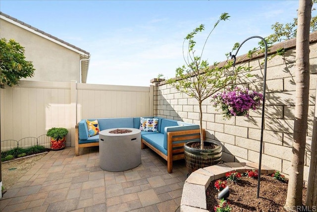 view of patio / terrace with an outdoor fire pit and fence
