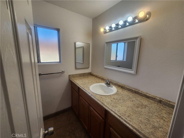 bathroom featuring tile patterned flooring, a wealth of natural light, and vanity