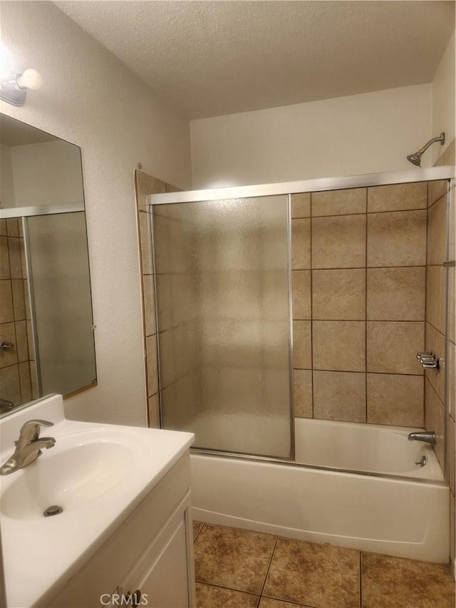 bathroom with vanity, tile patterned floors, and bath / shower combo with glass door