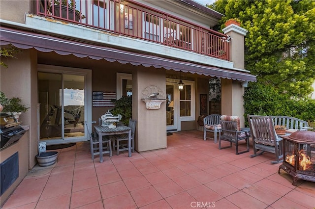 view of patio featuring a balcony