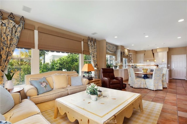 living room featuring light tile patterned flooring, visible vents, and recessed lighting