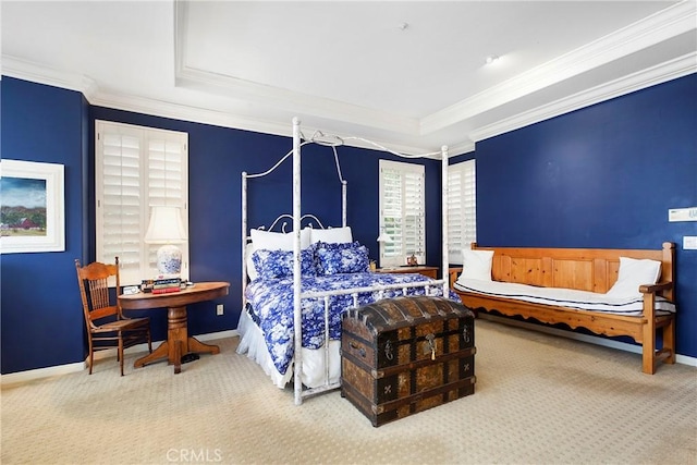 carpeted bedroom featuring a tray ceiling, baseboards, and crown molding