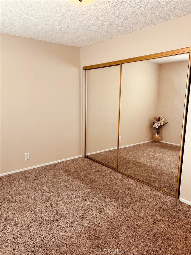 6252 Maloof Ave, Fontana, CA 92336 - unfurnished bedroom with baseboards, carpet, a closet, and a textured ceiling