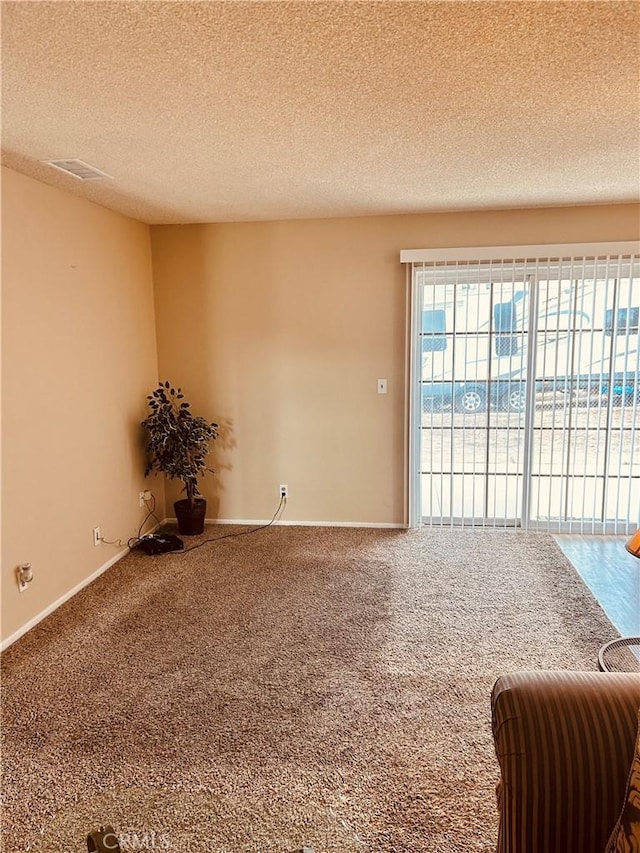 6252 Maloof Ave, Fontana, CA 92336 - spare room featuring a textured ceiling, carpet, and visible vents