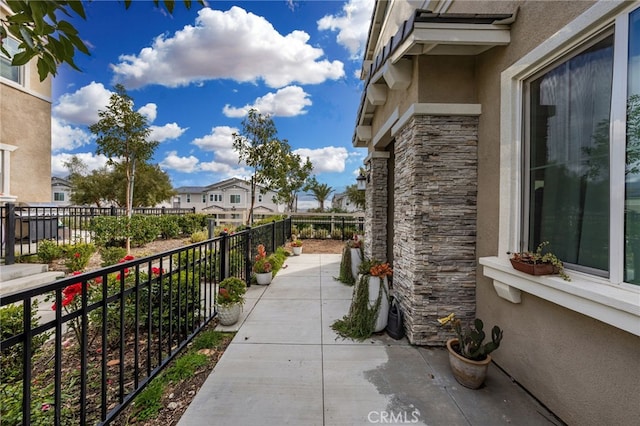 view of patio featuring a residential view and fence