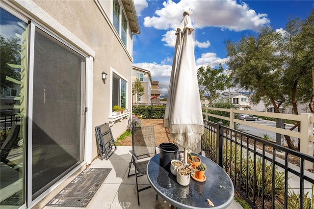 balcony featuring a residential view and outdoor dining area