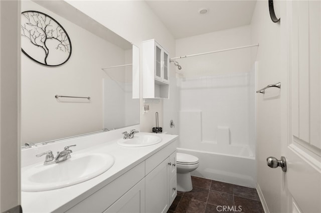 bathroom with shower / tub combination, toilet, a sink, and double vanity