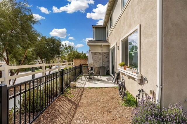view of yard featuring a patio, fence, and outdoor dining space
