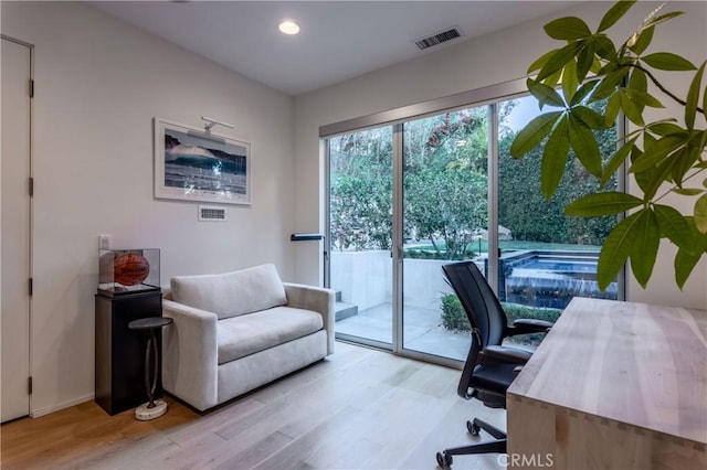 home office featuring recessed lighting, visible vents, and wood finished floors