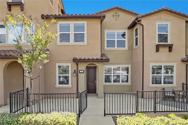 multi unit property featuring stucco siding and fence