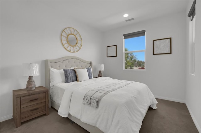 carpeted bedroom featuring visible vents and baseboards