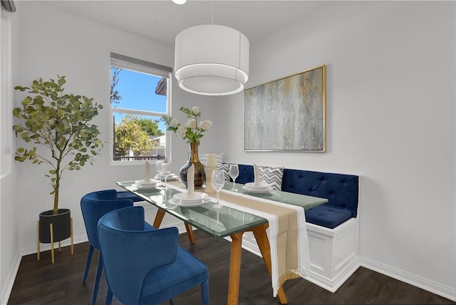 dining room featuring baseboards and dark wood-style flooring