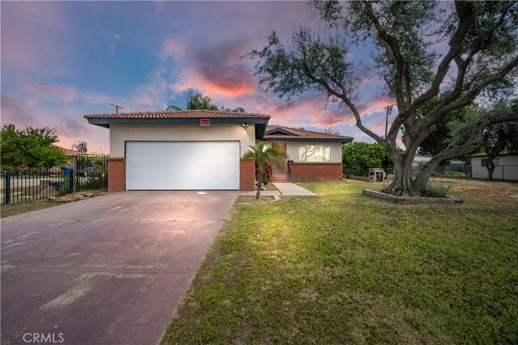 822 Dover Pl, Bakersfield, CA 93215 - view of front of home with fence, an attached garage, driveway, a front yard, and brick siding