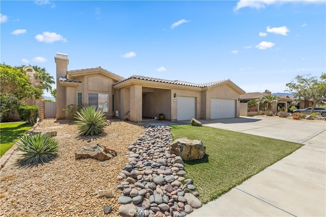 74119 Academy Ln E, Palm Desert, CA 92211 - view of front of home with a garage, driveway, stucco siding, a tile roof, and a chimney