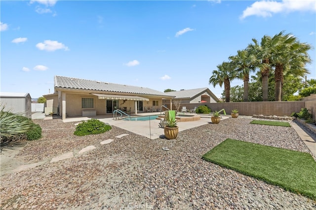 74119 Academy Ln E, Palm Desert, CA 92211 - back of house with a patio, a fenced backyard, stucco siding, a tile roof, and a pool with connected hot tub