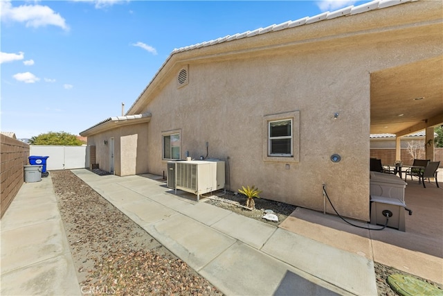 74119 Academy Ln E, Palm Desert, CA 92211 - rear view of property with a patio, a fenced backyard, central AC unit, and stucco siding