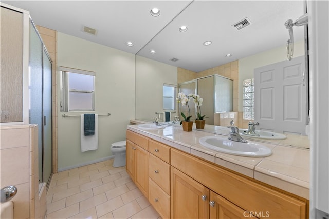 74119 Academy Ln E, Palm Desert, CA 92211 - full bathroom featuring a shower stall, double vanity, tile patterned floors, recessed lighting, and toilet