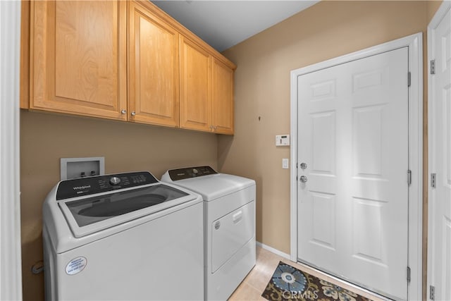 74119 Academy Ln E, Palm Desert, CA 92211 - laundry area featuring washing machine and dryer, cabinet space, baseboards, and light tile patterned flooring