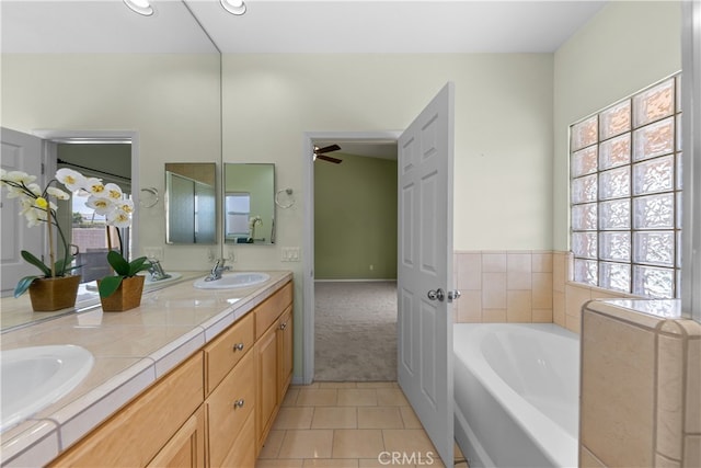 74119 Academy Ln E, Palm Desert, CA 92211 - bathroom featuring tile patterned floors, a garden tub, double vanity, a ceiling fan, and recessed lighting