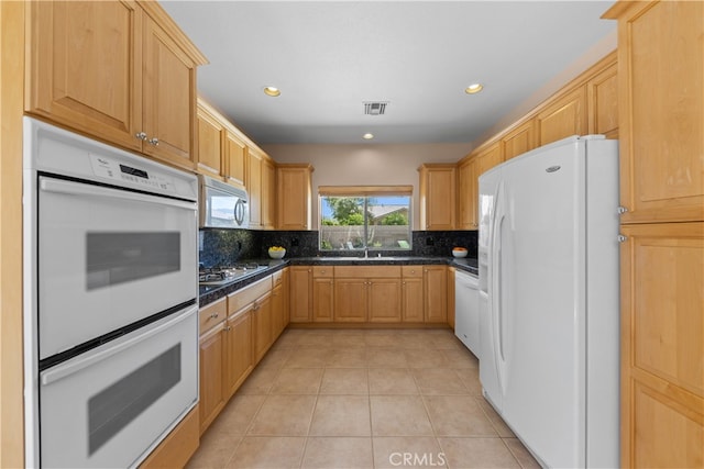 74119 Academy Ln E, Palm Desert, CA 92211 - kitchen featuring white appliances, dark countertops, tasteful backsplash, light brown cabinetry, and recessed lighting