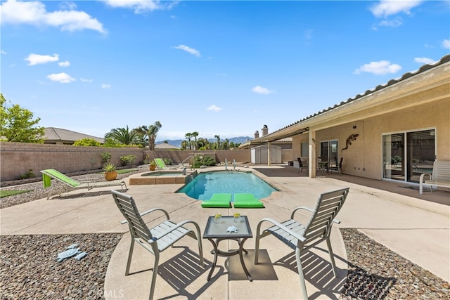 74119 Academy Ln E, Palm Desert, CA 92211 - view of pool with a fenced backyard, a patio, a mountain view, and a pool with connected hot tub