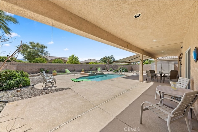 74119 Academy Ln E, Palm Desert, CA 92211 - view of pool featuring a patio area, outdoor dining area, a fenced backyard, and a pool with connected hot tub