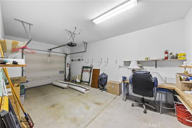 74119 Academy Ln E, Palm Desert, CA 92211 - garage featuring a garage door opener and a desk