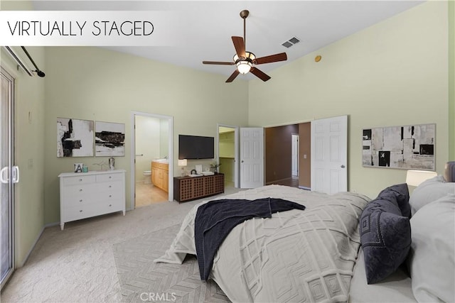 74119 Academy Ln E, Palm Desert, CA 92211 - bedroom with high vaulted ceiling, light colored carpet, and ensuite bath