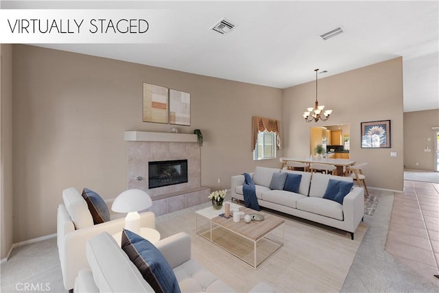 74119 Academy Ln E, Palm Desert, CA 92211 - living area with a chandelier, a tiled fireplace, baseboards, and light tile patterned floors