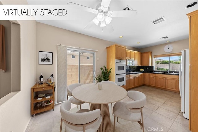 74119 Academy Ln E, Palm Desert, CA 92211 - dining room featuring light tile patterned flooring, a ceiling fan, and baseboards