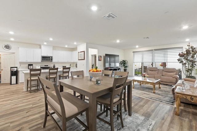 dining space featuring recessed lighting, visible vents, and light wood-type flooring