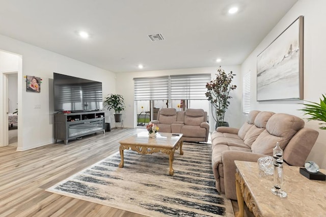 living room with baseboards, recessed lighting, wood finished floors, and visible vents