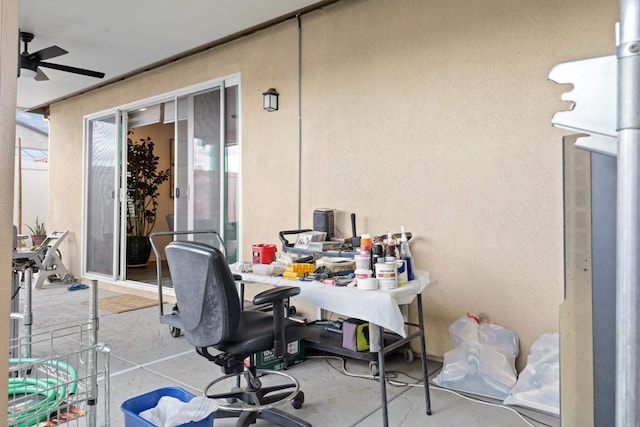 office space with ceiling fan and concrete floors