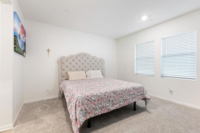 bedroom featuring baseboards, recessed lighting, and light carpet
