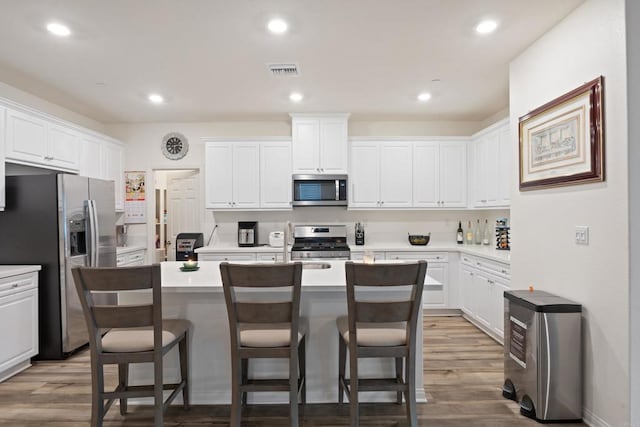kitchen featuring visible vents, white cabinetry, and appliances with stainless steel finishes