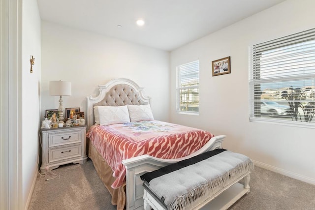 carpeted bedroom featuring baseboards and recessed lighting