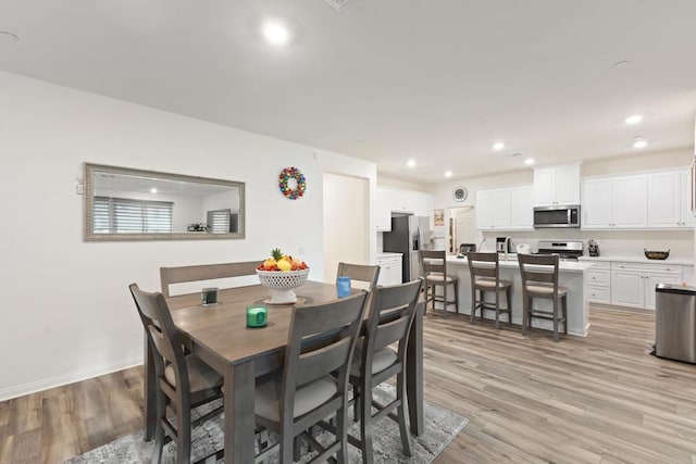 dining space with recessed lighting, baseboards, and light wood-style flooring