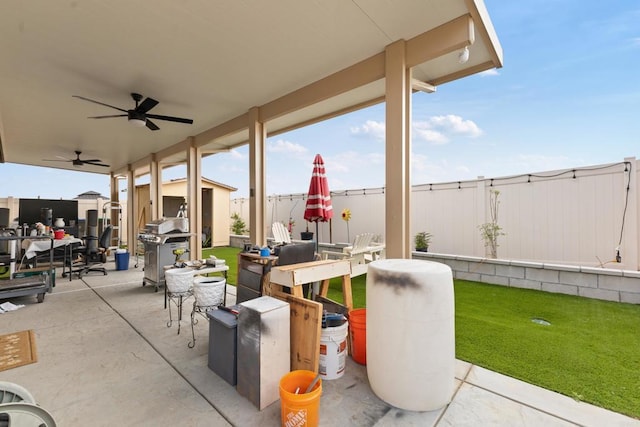 view of patio with a storage unit, ceiling fan, a fenced backyard, outdoor dining area, and an outdoor structure